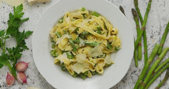 Homemade Tagliatelle Pasta with Creamy Ricotta Cheese Sauce and Asparagus Served White Ceramic Plate