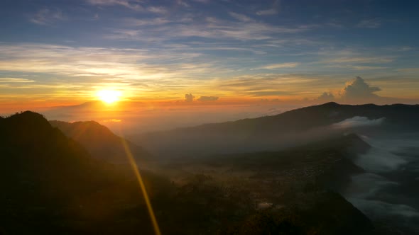 Sunrise Nature Landscape of Java Island in Indonesia. Clouds, Mountains and Fog. Panning Shot