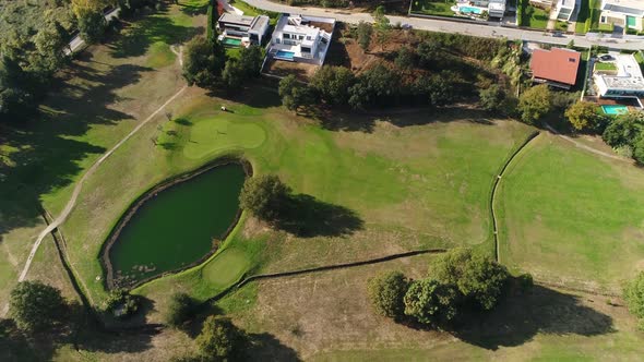 Golf Players and Lake