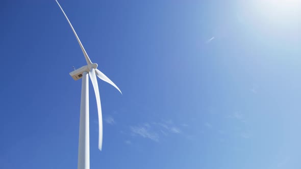 Cinematic Windmills on Clean Blue Sky Background with Sun Shining Brightly 6K US
