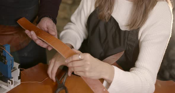 Leather Craftsman Working with a Belt in a Workshop