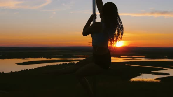 Pole Dance on Sunset - Attractive Woman with Long Braids Dancing
