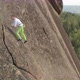Aerial View of a Young Brave Man Climbing a Rock Wall Without Insurance. Extreme Ascent To the Top - VideoHive Item for Sale