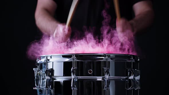 Playing Drums with Colorful Pink Powder Closeup