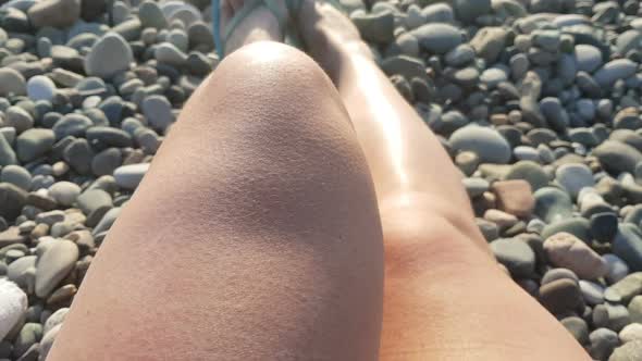 Woman Laying on the Beach Female Legs Relaxing on Seaside Sunset Pov