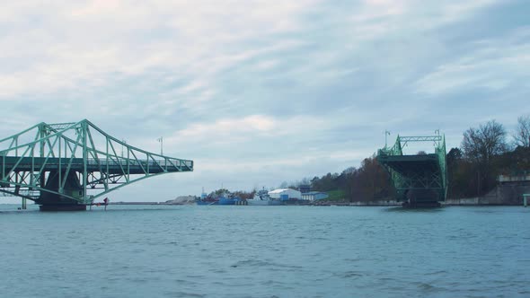 Timelapse of closing Oskara Kalpaka swing bridge in Liepaja in cloudy autumn day, wide shot