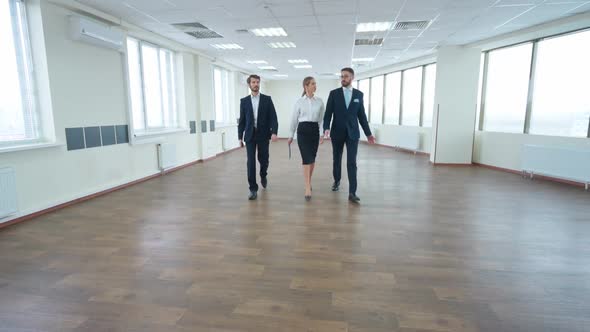 Business Meeting Team of Top Managers Walk to Meet the Interior of a White Office Space with