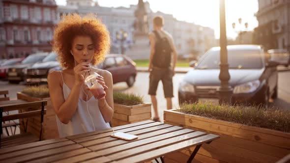 Girl Listening Music Drinking Smoothie Smiling Resting in Cafe Slow Motion