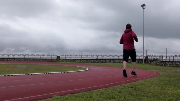 Runner Running on Running Track