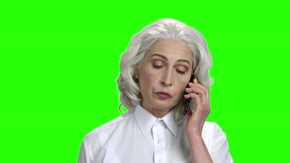 Serious Elderly Woman Talking on Phone