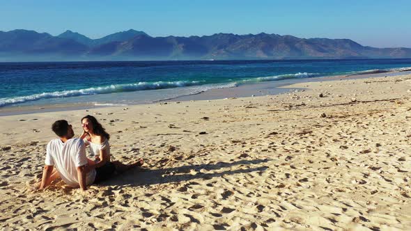 Happy boy and girl on honeymoon vacation spend quality time on beach on sunny white sandy background