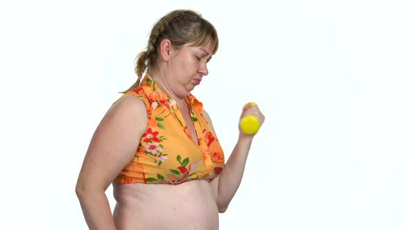 Obese Woman Doing Exercise with Dumbbell