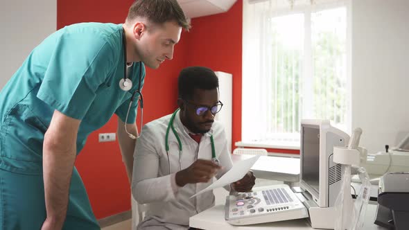 Vet Doctor and Assistant Discuss Pet Pathology