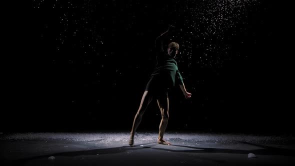 Contemporary Ballet, a Man Performs Elements of Modern Choreography and Jumps in the Spotlight