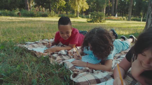 Closeup of Multiracial Diverse School Children Writing Exam Outdoors