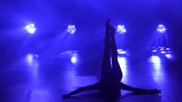 Professional Ballerina in Black Bodysuit Gracefully Dancing Ballet. Shot in Dynamic Spotlights and