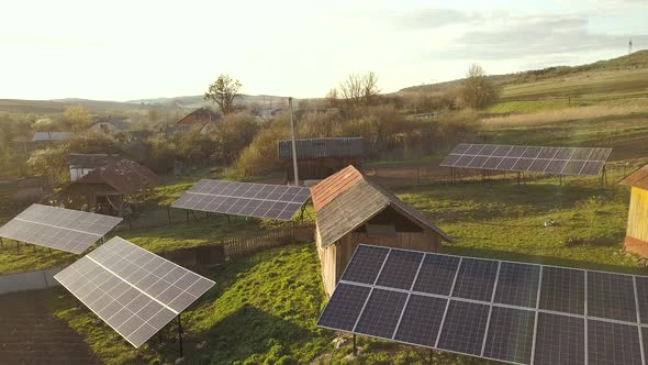 Aerial Top Down View of Solar Panels in Green Rural Village Yard