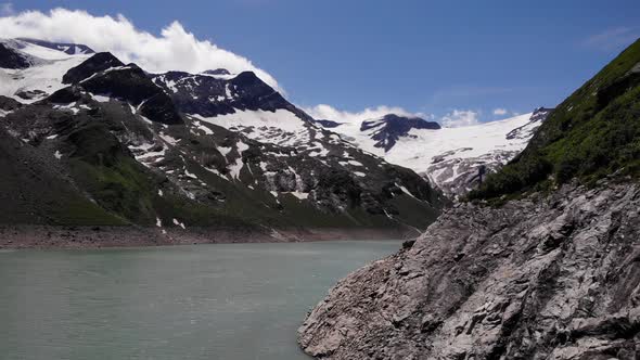 Snowy Rocky Mountains At Stausee Wasserfallboden Lake In Kaprun, Austria. - Aerial Shot