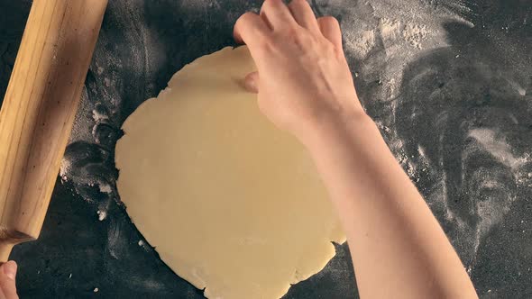 Woman prepares butter cookies at home in the kitchen.