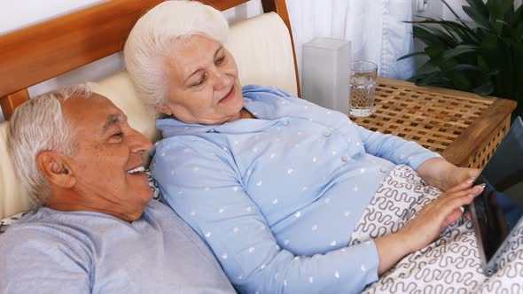 Senior couple using digital tablet