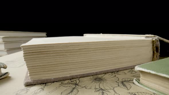 Open Book with Blank White Paper Pages Isolated on Black Studio Background alt