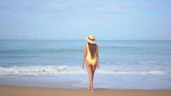 Asian woman enjoy around beautiful beach sea ocean