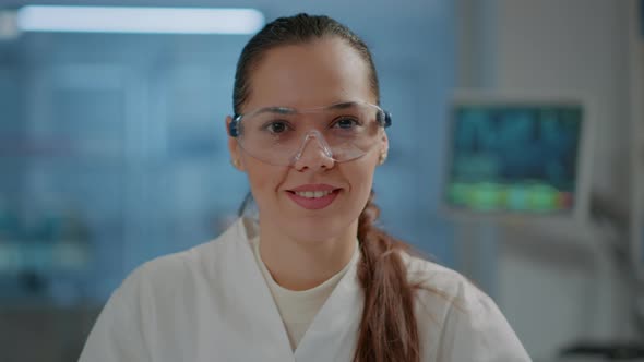 Portrait of Woman Scientist with Goggles Smiling in Laboratory