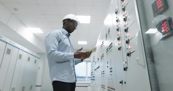 Portrait of an Engineer in a Hard Hat Holding a Tablet