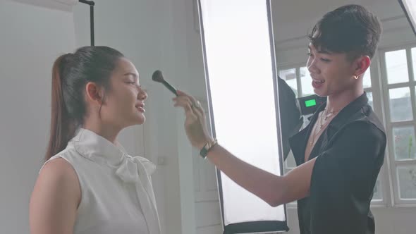 Backstage Of The Photo Shoot: Make-Up Artist Applies Makeup On Beautiful Asian Model