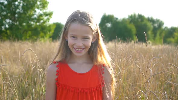 Beautiful Little Blonde Girl, Has Happy Fun Cheerful Smiling Face, Red Dress