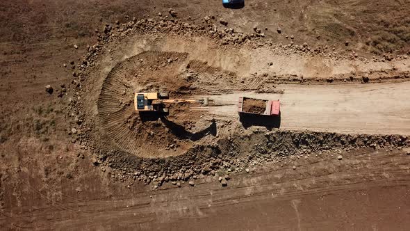 Top Down View of Excavator Working in Construction Site