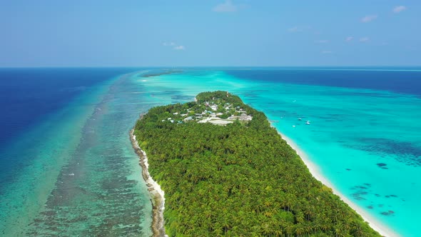 Daytime fly over tourism shot of a white sandy paradise beach and aqua blue ocean background