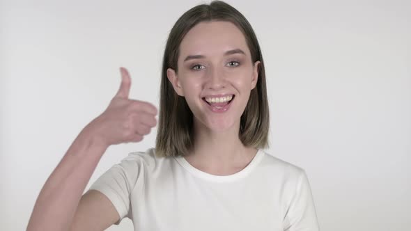 Young Woman Gesturing Thumbs Up on White Background