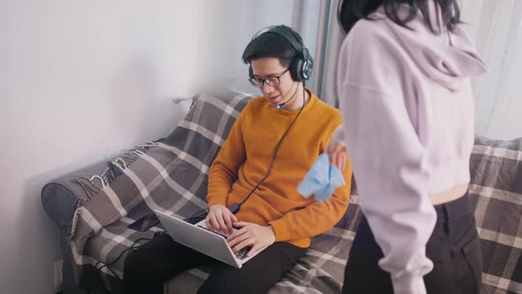 Young Man Playing Games on His Laptop and Ignoring His Girlfriend