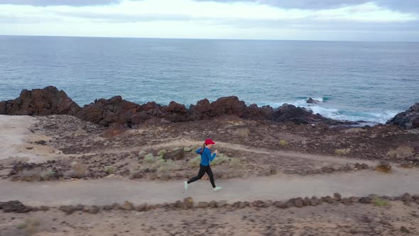 Aerial View of Woman Runnning Along the Nature Reserve. Healthy Active Lifestyle