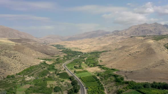 Aerial Drone Shot of Armenia Landscape and Cars on the Road in Summer