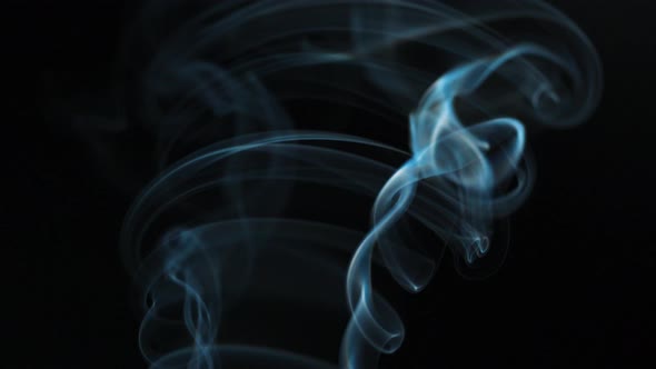 Abstract Smoke Rises Up in Beautiful Swirls on a Black Background