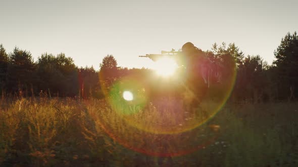 Steadicam Slow Motion Shot: Silhouette of a Running Man. The Soldier in the Attack, Holding a Gun