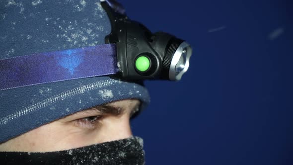 Close Shot Ski Tourer Turning on Headlamp