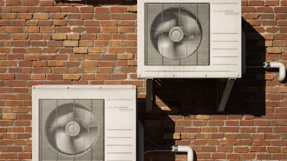 Multiple outdoor air-conditioner units on the brick wall during the day. 4K HD