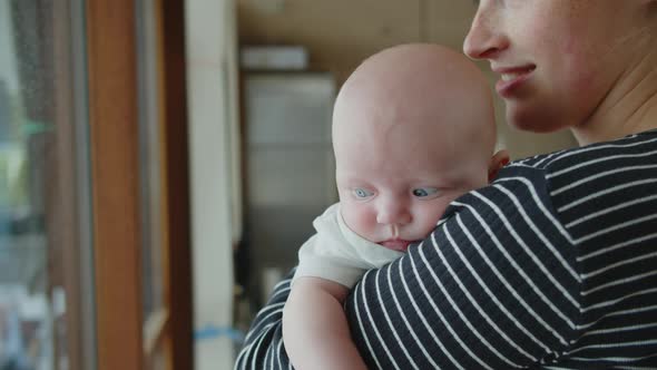 Baby Girl Resting In Her Mother's Arms