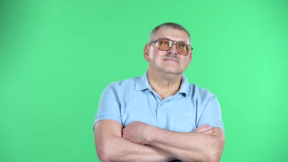 Portrait of Aged Man Is Waiting, Isolated Over Green Background.