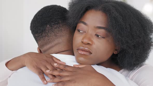 Closeup View Black Female Face of Sad African Woman Embraces Unrecognizable Afro Man