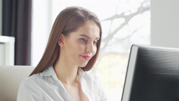 Young Woman Works at Home Office Using Computer.