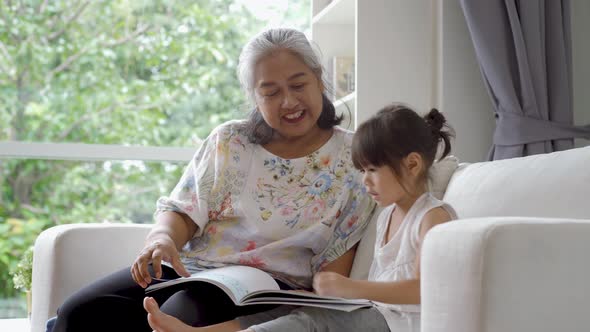 Elderly Asian Woman Teaching Her Granddaughter 05