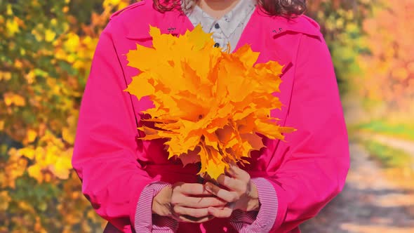 Female Hands with Autumn Leafs in Front