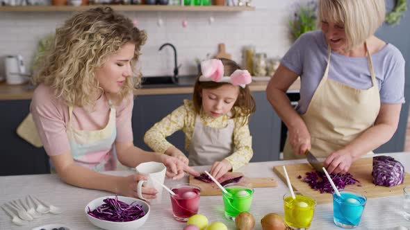 Tracking video of three generations of women in the kitchen. Shot with RED helium camera in 8K