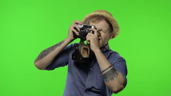 Portrait of Man Tourist Photographer Is Taking Photos on Camera. Chroma Key