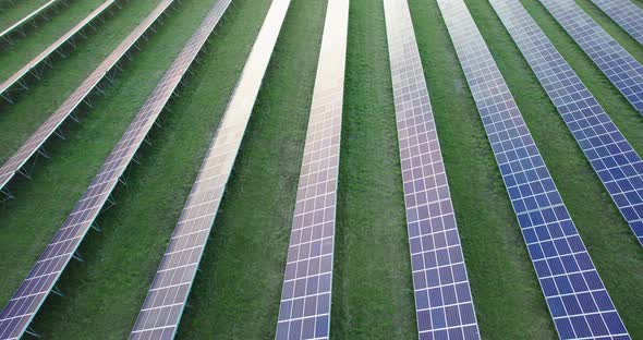 Solar Power Plant Panels in a Field with Green Grass