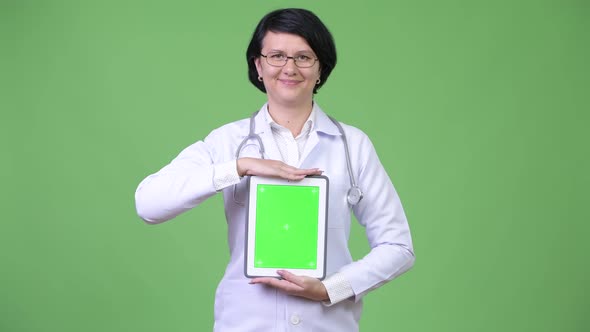 Beautiful Woman Doctor with Short Hair Showing Digital Tablet